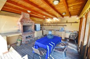 a patio with a table and a brick fireplace at Apartments Rajsko Mjesto in Tivat