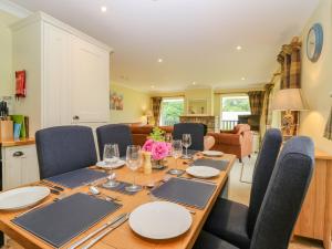 a dining room with a wooden table and chairs at The Lodge in Blairgowrie