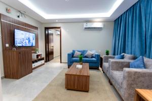 - un salon avec deux canapés et une télévision dans l'établissement Hyatt Residence, à Abha