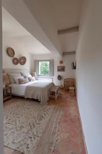 a bedroom with a large bed and a window at Domaine de la Xavolière in Saint-Cézaire-sur-Siagne