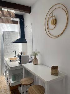 a kitchen with a table and stools in a room at Casa Arequipa in Vejer de la Frontera