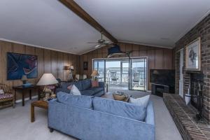 a living room with a blue couch and a fireplace at Escape in Edisto Island