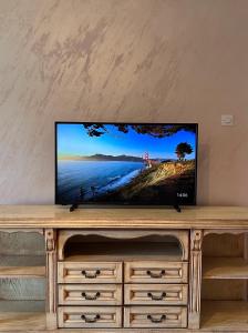 a flat screen tv sitting on top of a dresser at Apartment 777 in Bijelo Polje