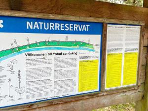 a sign for a natural interpretive sign at a park at 4 person holiday home in YSTAD in Ystad