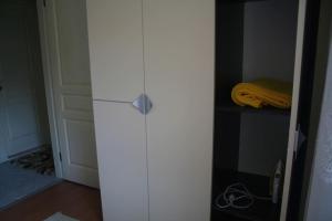 a white refrigerator in a room with a door at Konakli Apartments Izmir in Izmir