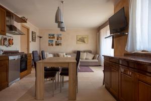 a kitchen and living room with a table and a couch at Cà da Cesare in Somendenna