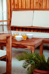 a wooden table with bowls on it with a couch at Da Paolo e Antonietta in Mazara del Vallo