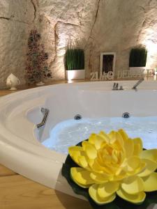 a bathroom with a tub, sink, and toilet at 21mq Suite Home in Ostuni