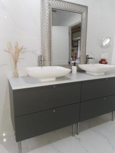 a bathroom with two sinks and a large mirror at Casa con piscina in Cedeira