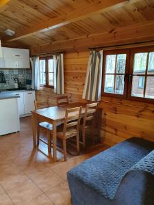 a kitchen and dining room with a table and chairs at Leśniczówka-Wdzydze Pe eL in Wdzydze Kiszewskie