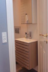 a bathroom with a sink and a mirror at Dock House 95-97 in Middelfart