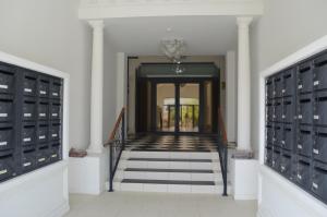 a hallway with stairs leading into a building with lockers at Studios Régina (Mer-Golf) in Biarritz