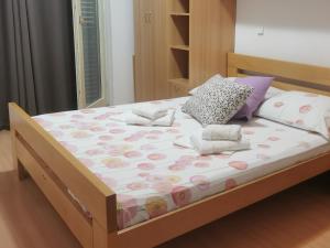 a bedroom with a bed with a wooden frame at Pine Apartment in Hvar