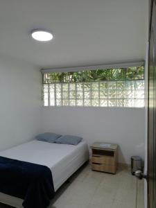 Een bed of bedden in een kamer bij CASA HOTEL BOTERO