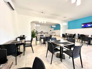 a dining room with tables and chairs at Agriturismo Antichi Ulivi in Mattinata