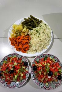 three plates of food with rice and vegetables on a table at Riad Atlas Imlil in Imlil +47 photos