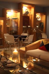 a living room with a couch and a candle on a table at Marina Club Lagos Resort in Lagos