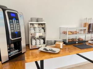 a counter with a coffee maker and a microwave at Agriturismo Antichi Ulivi in Mattinata +48 photos
