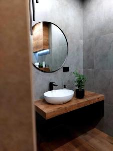 a bathroom with a white sink and a mirror at Silver 58 Zator in Zator +21 photos