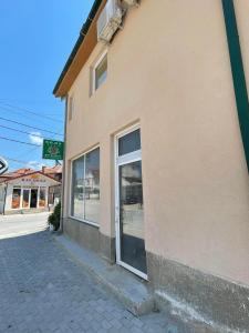 a store with glass doors on the side of a building at Vila 5 in Prilep