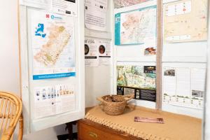 a desk with maps and charts on a wall at APARTAMENTS ROIG in Benasal