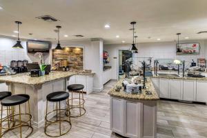 a large kitchen with bar stools in a store at Staybridge Suites Tyler University Area, an IHG Hotel in Tyler