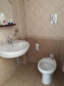 uma casa de banho com um lavatório e um WC em La tavernetta a Trinitapoli em Trinitapoli