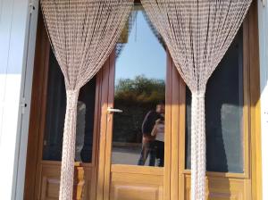 a pair of curtains on the door of a house at La tavernetta a Trinitapoli in Trinitapoli