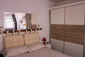 a bedroom with a bed with a mirror above it at La graciosa in Costa Del Silencio