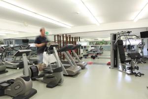 a man walking through a gym with cardio equipment at Marina Club Lagos Resort in Lagos