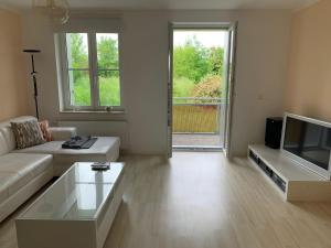 a living room with a couch and a tv at Apartment Am Jakobsweg in Erfurt