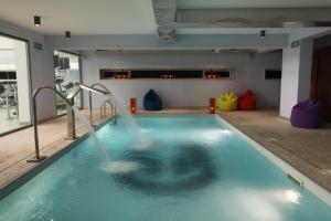 a swimming pool with a person in the water at Marina Club Lagos Resort in Lagos