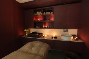 a bathroom with a sink and candles on a counter at Marina Club Lagos Resort in Lagos