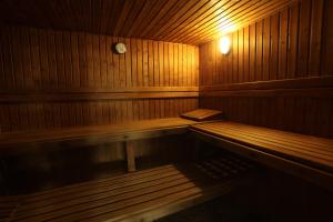 a wooden sauna with a bench in the middle at Marina Club Lagos Resort in Lagos
