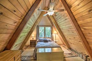 a bedroom in a log cabin with a ceiling fan at Lake Pepin Cottage with Decks and Private Beach! in Stockholm
