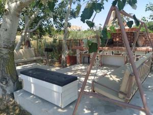 a swing set in the shade of a tree at VILLA PORTIANOU in Pedhinón
