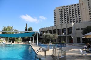 a swimming pool in front of a building at Jerusalem Hotel Private Luxury Suites near Western Wall in Jerusalem