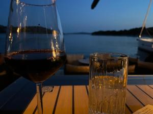a glass of wine sitting next to a glass of water at Rooms & Apartments Blue Beach in Vodice