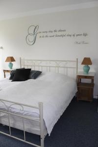グラセンにあるDet Gamle Apotek Bed & Breakfastのベッドルーム1室(壁に看板付)