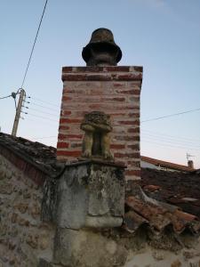 a brick chimney on the roof of a building at Gatekeepers Cottage Tiny House in Taizé