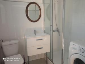 a bathroom with a sink and a toilet and a mirror at P-4 in Retowo
