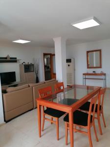 a living room with a table and chairs and a couch at Apartamento mirador del Mar in Las Palmas de Gran Canaria