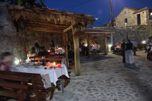 a group of people sitting at a table with candles at Apartment Stanisic in Budva