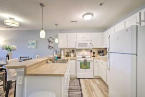 A kitchen or kitchenette at Screened Balcony with Views Sleek Lake Ozark Gem!