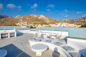 a view from the roof of a house with tables and chairs at Thalasidi Luxury Suites in Karpathos Town