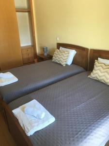 a bedroom with two beds with towels on them at Lagos Royal Rooms and Suites in Lagos