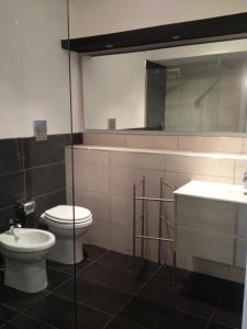 a bathroom with a toilet and a sink and a mirror at Mulino in Cefalù +12 photos