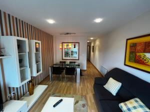 a living room with a couch and a table at OKTHEWAY MALPICA in Malpica