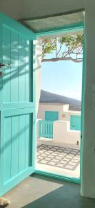 an open door to a balcony with a view of the ocean at Serifos Sugar Cubes in Serifos Chora