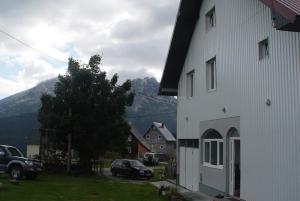 a white building with a view of a mountain at Apartmani panorama in Žabljak